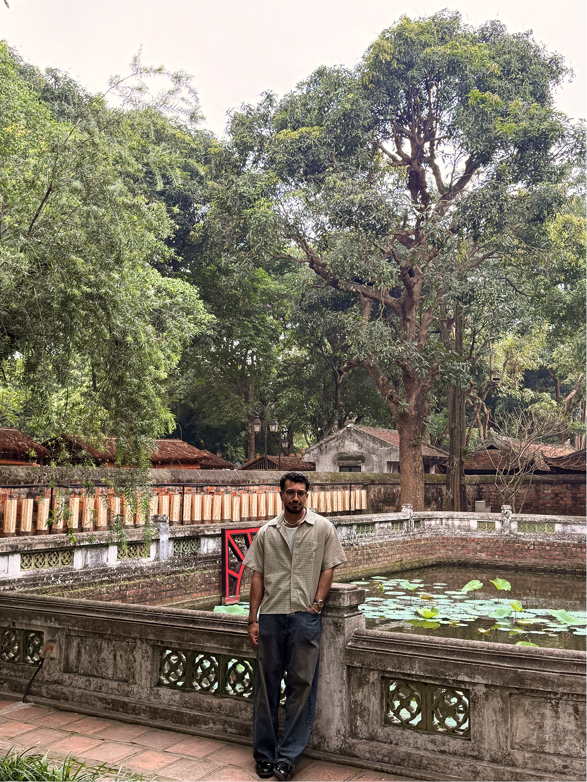 Omar by a lotus pond at the Temple of Literature, Hanoi